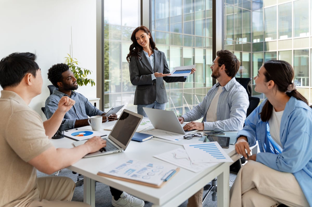 Executive leader presenting to colleagues in a modern boardroom
